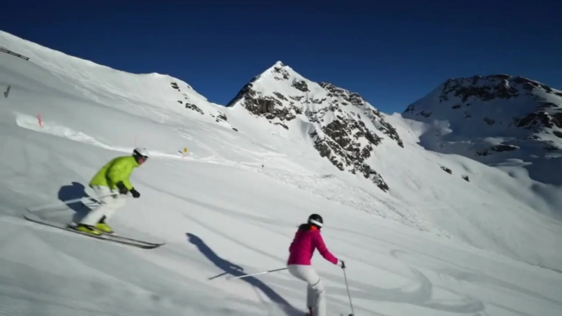 Ski goggles reflecting snow-covered mountains and forested slopes during winter