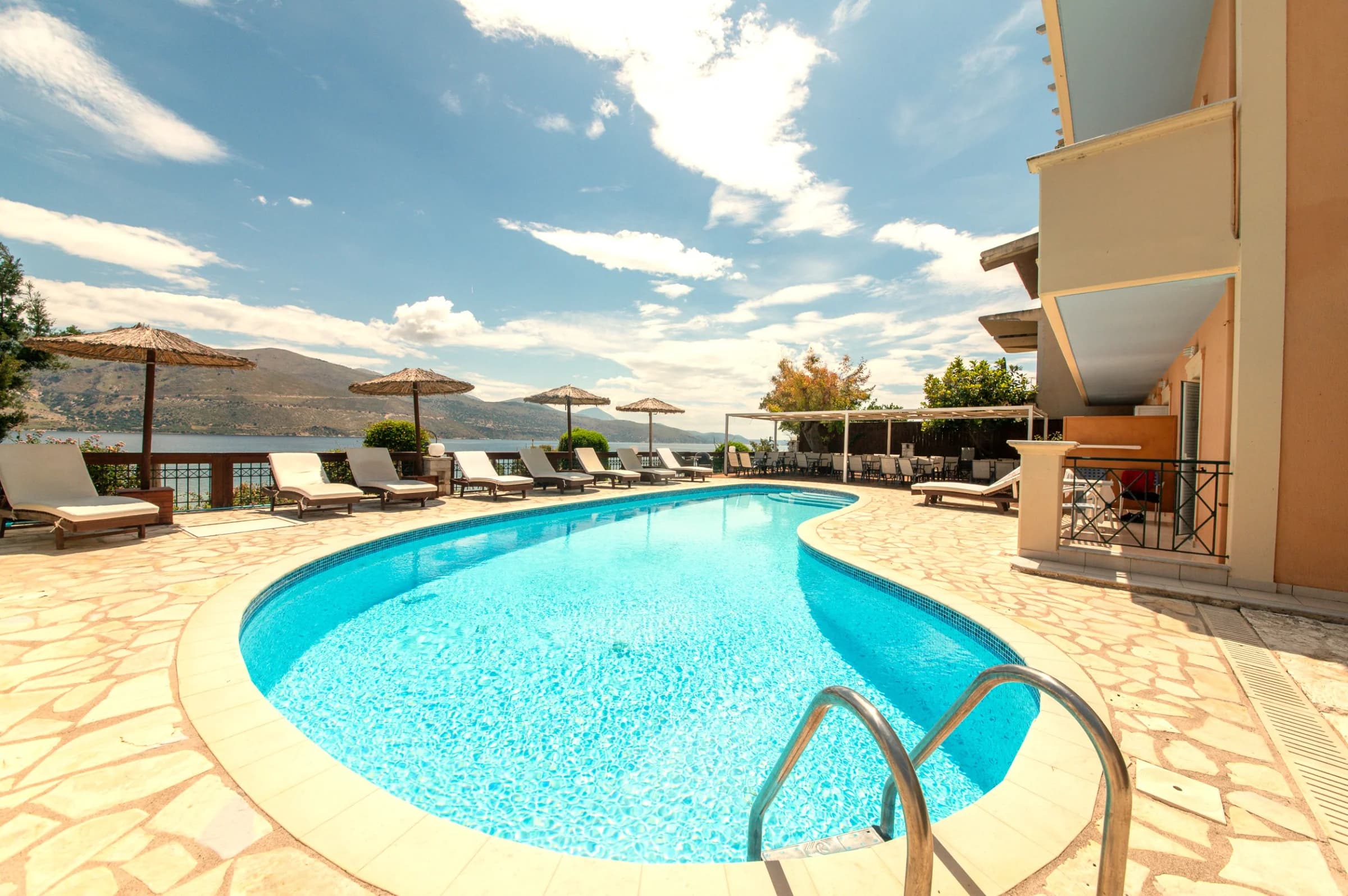 Swimming Pool at a beach club with sun loungers 