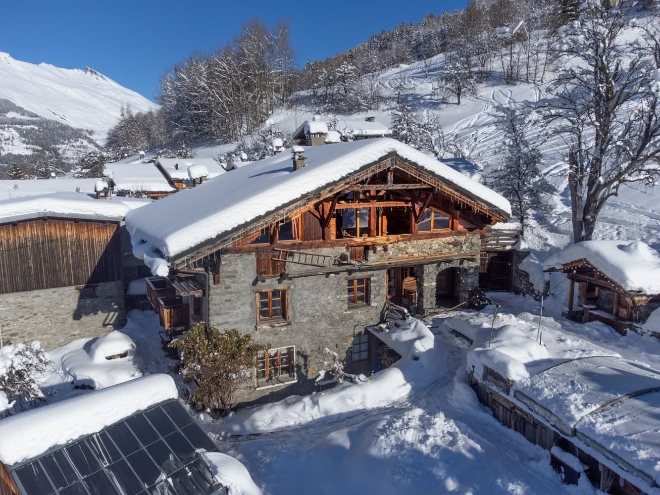 Chalet La Grange d'Alice from above after fresh snow, its timber gable and stone walls in the hamlet of Les Granges, Les Arcs