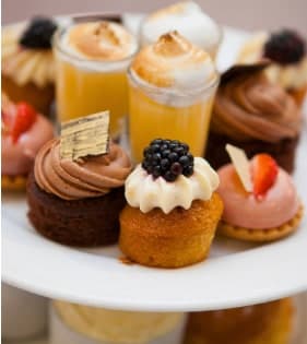 Afternoon tea stand of cupcakes, tarts and meringues