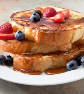 French toast with strawberries, blueberries and maple syrup at chalet breakfast